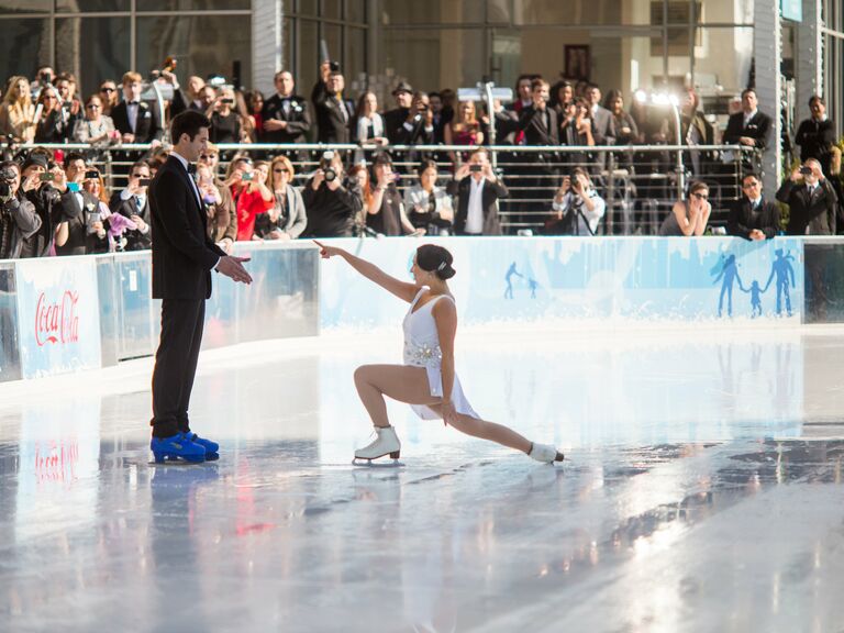 Bride and groom doing a ice skating performance.