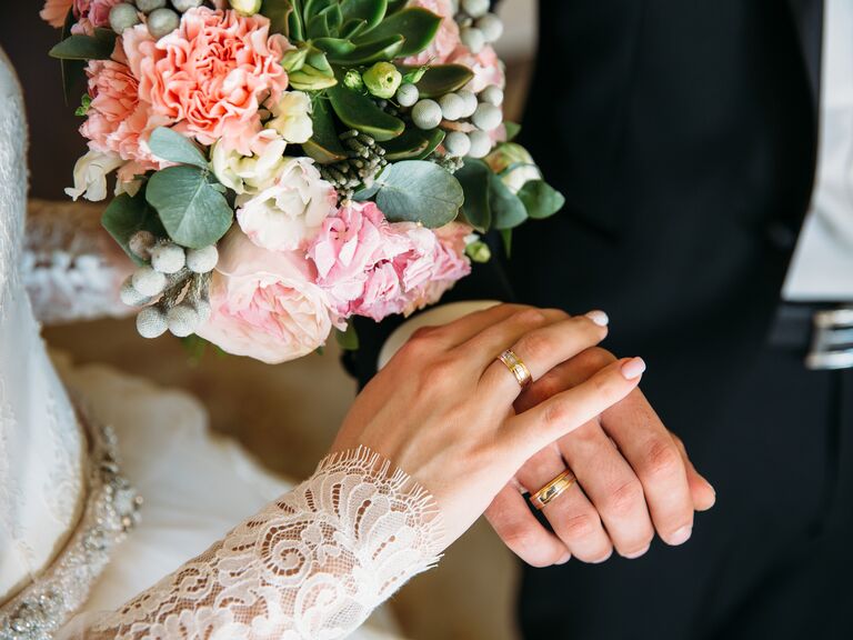 Bride and groom holding hands