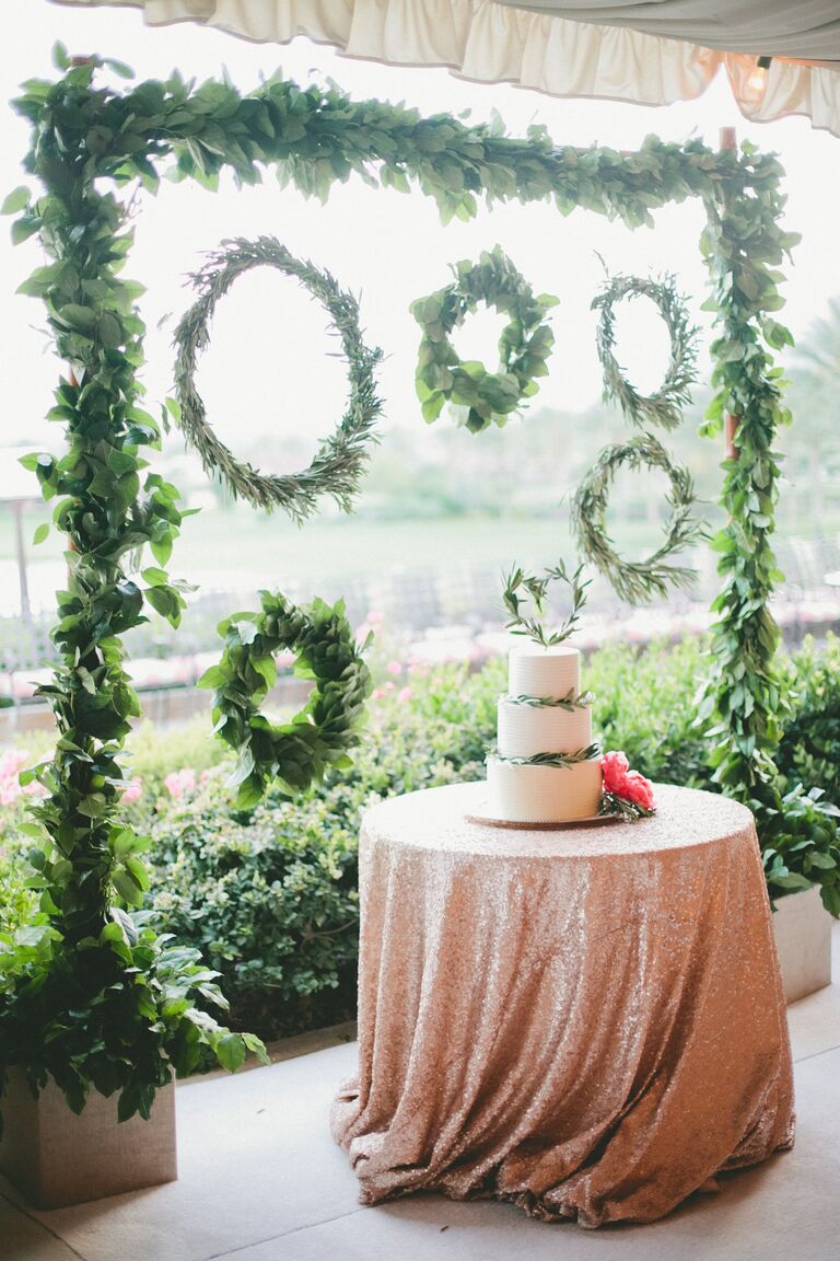 White wedding cake with green wreaths