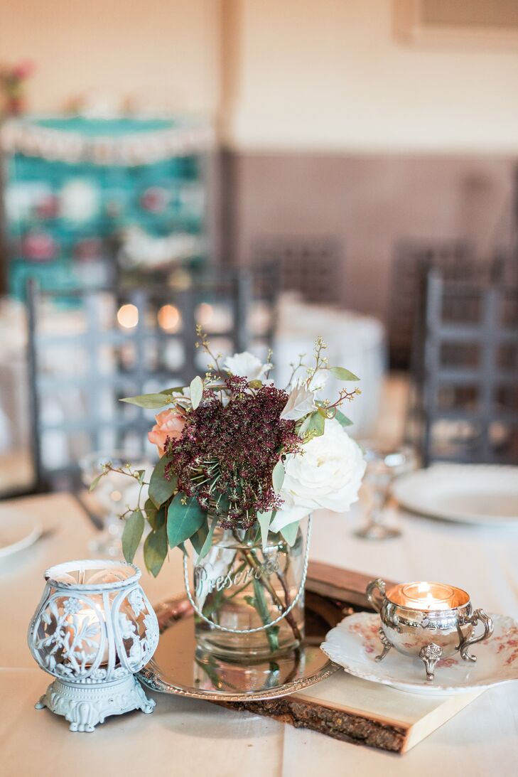 No two dining tables looked the same: Each centerpiece included vintage touches such as old frames, clocks, books and candles, with fresh flowers.