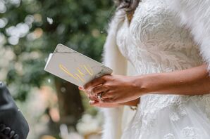Bride Holding Gray-and-Gold Vow Book During Elopement at the Anderson House in Washington, DC
