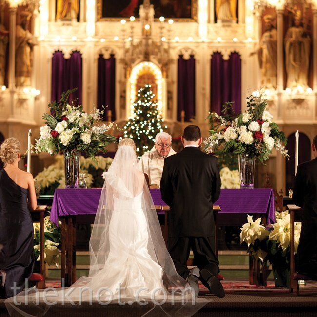 Holy Family Church, which is associated with the high school Katie and Matt attended, was already decorated for Christmas, so the couple brought in just two lush white-andred floral arrangements.