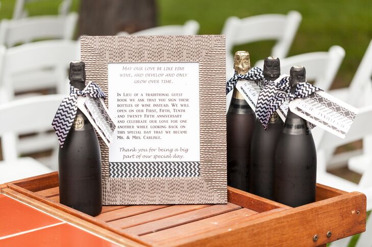 Black-painted wine bottles had black-and-white-striped ribbon wrapped around the neck. Guests signed the bottles as an alternative to a guest book.