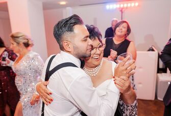 A groom with his mother dancing at the wedding