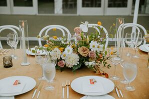 Reception Table With Burnt Orange Linen, White Chargers, Low and Bright Centerpieces, Candles