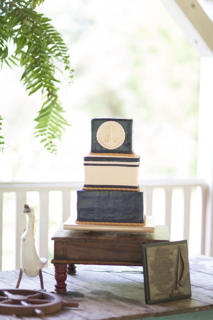 The square groom's cake was three layers and had a nautical theme. Each layer was accented with rope-like piping and the top layer was marked with a anchor embellishment.