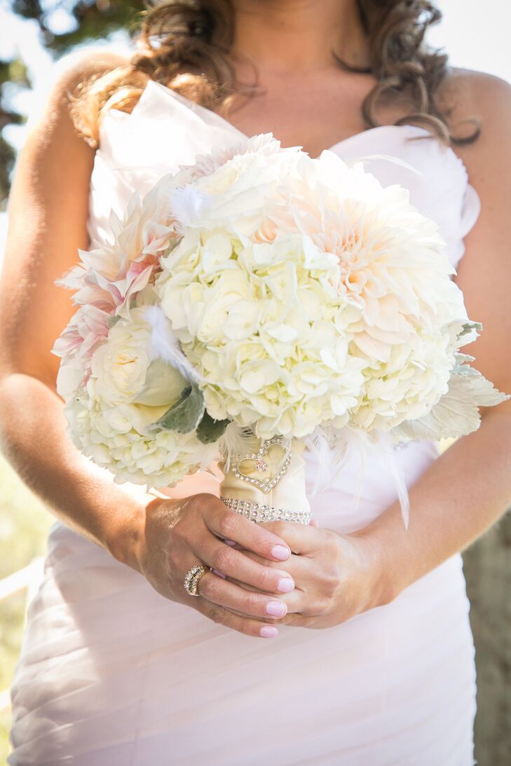 Kelli held an ivory and pink bouquet filled with hydrangeas, dahlias, ranunculus and roses accented with dusty miller.