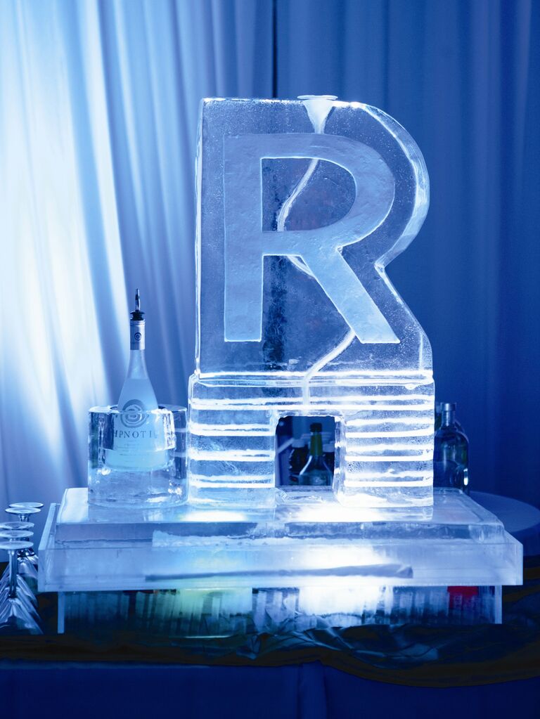 2023 wedding reception trend idea monogrammed ice sculpture turned into shot luge