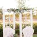 Pale lavender Louis XV chairs and an upcycled French door backdrop added an elegant, shabby-chic flair to the decor.