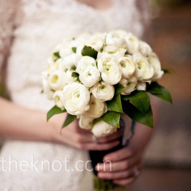 For her bouquet, Erica went with white ranunculus instead of traditional roses. She tied the flowers with a black ribbon for a vintage look.