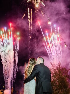 Couple Kissing During Post-Wedding Fireworks