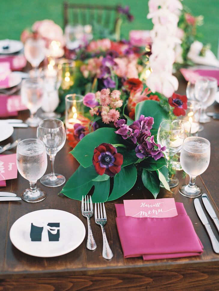 Centerpieces matched the bright pink and rich green palette and were made of pink plumeria, hibiscus, calla lilies and glossy greenery.