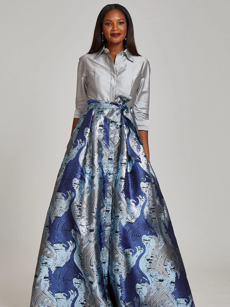 A model shows off this absolutely stunning shirt-skirt combination in silver and metallic blue.
