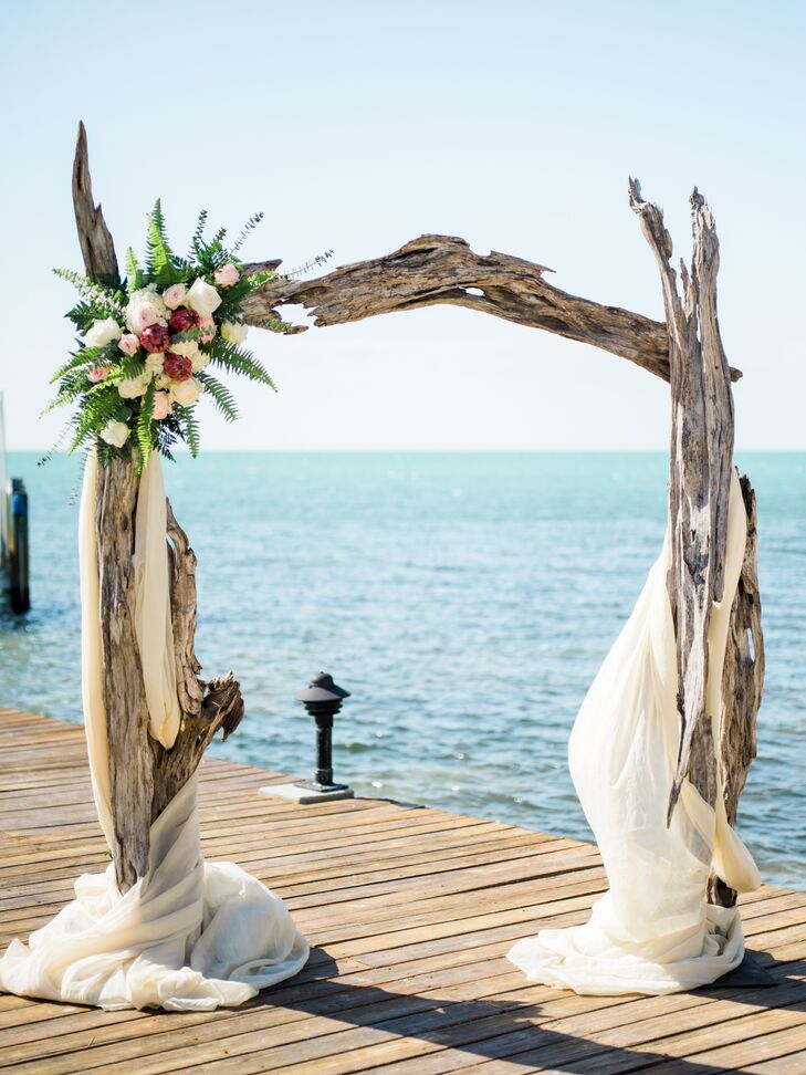 "I knew I wanted the driftwood arch. I had seen every blog on every Florida Keys wedding going back five years, and I just had to have that arch," Nicole says. For the rest of her ceremony decor, she borrowed lanterns from her neighbor, filled them with candles and white rose petals. "Other than that, we let the arch and ocean speak for themselves."