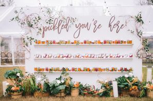 Escort Card Display Filled With Jars of Homemade Pickles