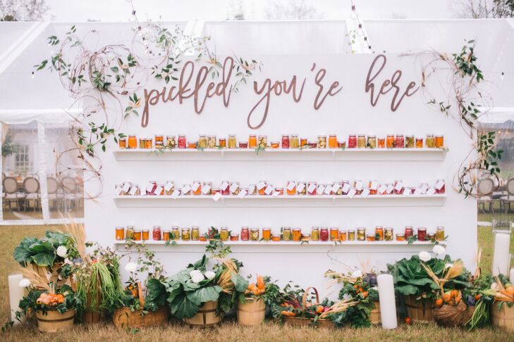 Escort Card Display Filled With Jars of Homemade Pickles