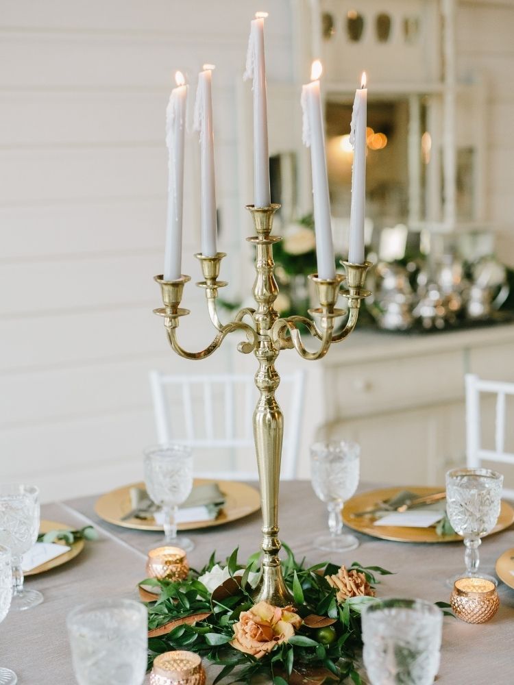 gold candelabra with white taper candles