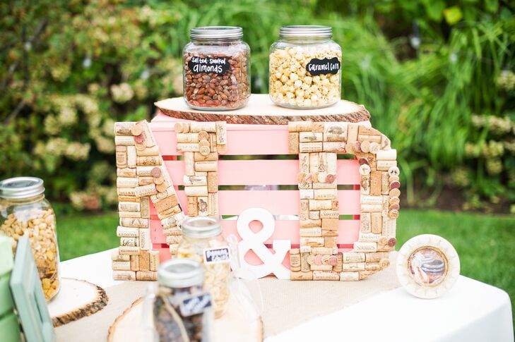 Mason jars of almonds, popcorn and candies were made available to guests at the reception at Rancho Soquel in Aptos, California. Danielle made the "N&D" initials from dozens of corks.