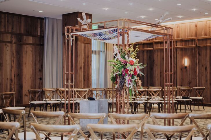 Copper chuppah inside hotel ballroom.