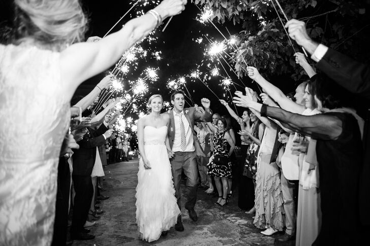 Sarah wore a beautiful strapless Liancarlo dress with a fitted sweetheart bodice, embellished belt and a delicate ruffled skirt. Her style allowed her to be comfortable outdoors and dance all night at the reception—plus, she wore cowboy boots to go with the Texas theme.