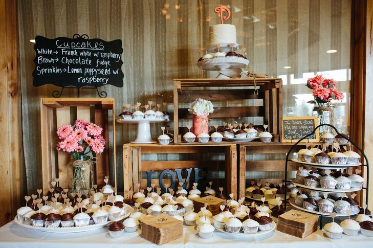 Cupcake arrangements on a variety of different stands were positioned around wooden crates throughout the dessert display. Kellie and Nathan had a single-tier wedding cake accented with a coral topper to cut during the reception.