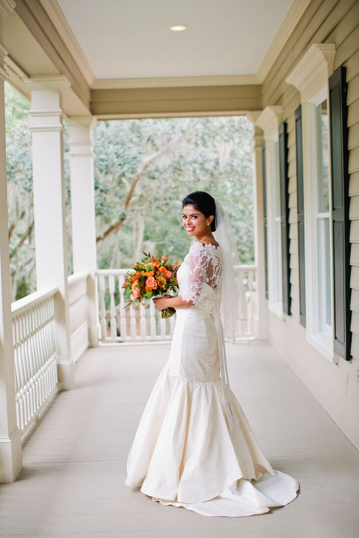 Amanda donned a striking fit-and-flair gown with a small train. She accessorized the dress with a lace bolero that she wore for the Catholic Mass ceremony and then removed at the reception.