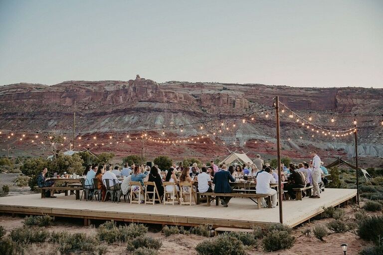 Sunset reception in the desert with string lights