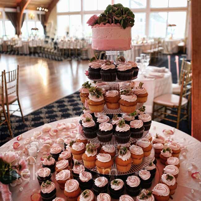 Vanilla and chocolate cupcakes filled out five of the six tiers in the tower. The couple cut into a small, pink cake which sat on top.