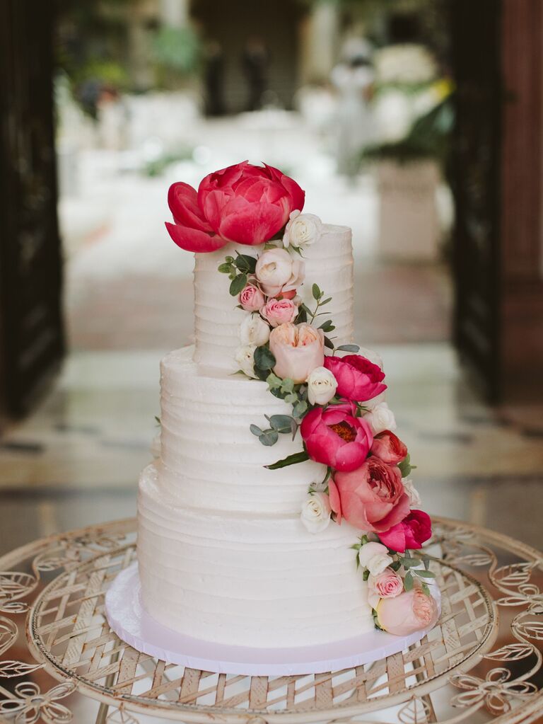 buttercream wedding cake with magenta peonies