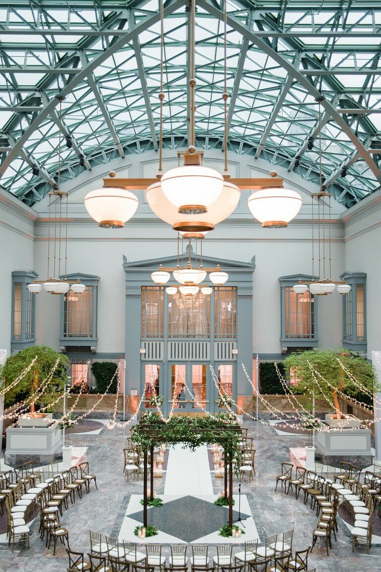 Ceremony in the round in large atrium with glass ceiling