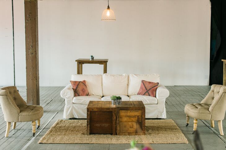 With ample space to work with and a small guest list, Lauren and Dave were able to make the most of their venue’s unique open floor plan. They set up vignettes throughout the room to create an intimate feel, with strands of bistro lights distinguishing the dining area and a cozy lounge area complete with sofas, arm chairs, vintage rugs and a bar providing a chic place for guests to mix and mingle before dinner.