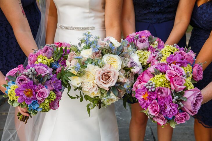 The bridesmaids bunched their bright purple round bouquets together, with Jackie's bouquet in the middle. The bridesmaid arrangements of roses, hydrangeas, silver brunia, ivy and jasmine made up the round shapes. The bridal bouquet embodied similar blooms but in shades of blush and champagne, all arranged by Plantscaping and Blooms.