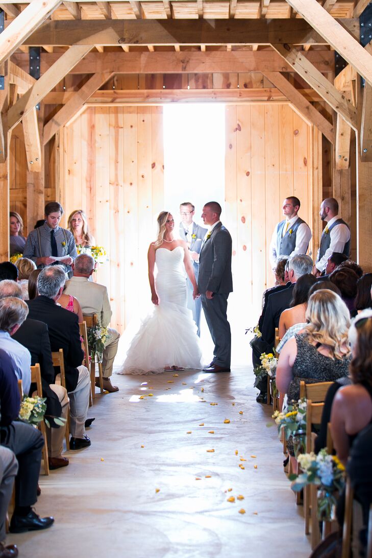 The ceremony took place inside the barn at  Amador Cellars in Plymouth, California, with minimal decor for an all-natural look. Lauren and Drake stood in front of the barn doors, with a slight gap letting in light to illuminate the space.