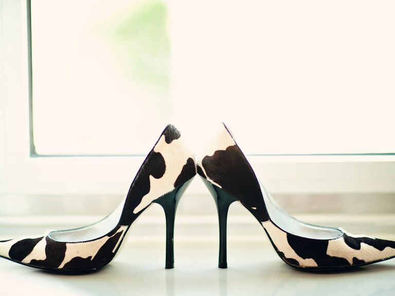 Cow-print high heels with a pointed toe. 
