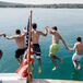 Guests Jump Off Dock at Private Estate Wedding at Lake Michigan