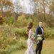 Bride in White, Magenta and Green Wedding Dress With Train, Half-Up Hairstyle and Groom