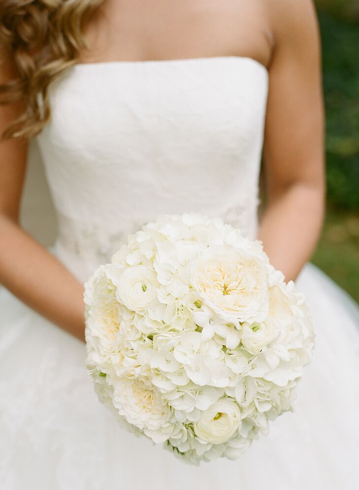 To complement her timeless bridal style, the florists at Flowers on the Vineyard created a lush, ivory bouquet filled with romantic full blooms like garden roses, freesia, ranunculuses and hydrangeas for Caity to carry down the aisle. The bridesmaids carried similar arrangements in soft shades of blush and ivory that popped against their navy gowns.