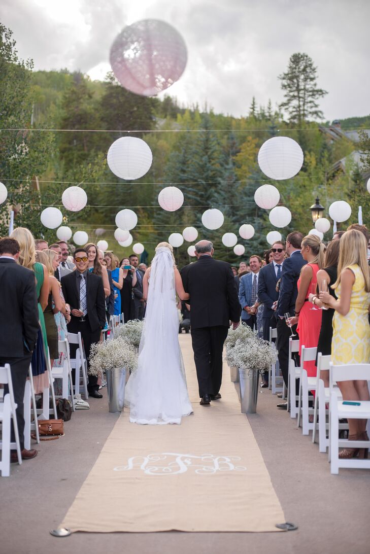 Ashley ordered a monogrammed burlap aisle runner from Etsy and lined the aisle with galvanized tins full of baby’s breath.