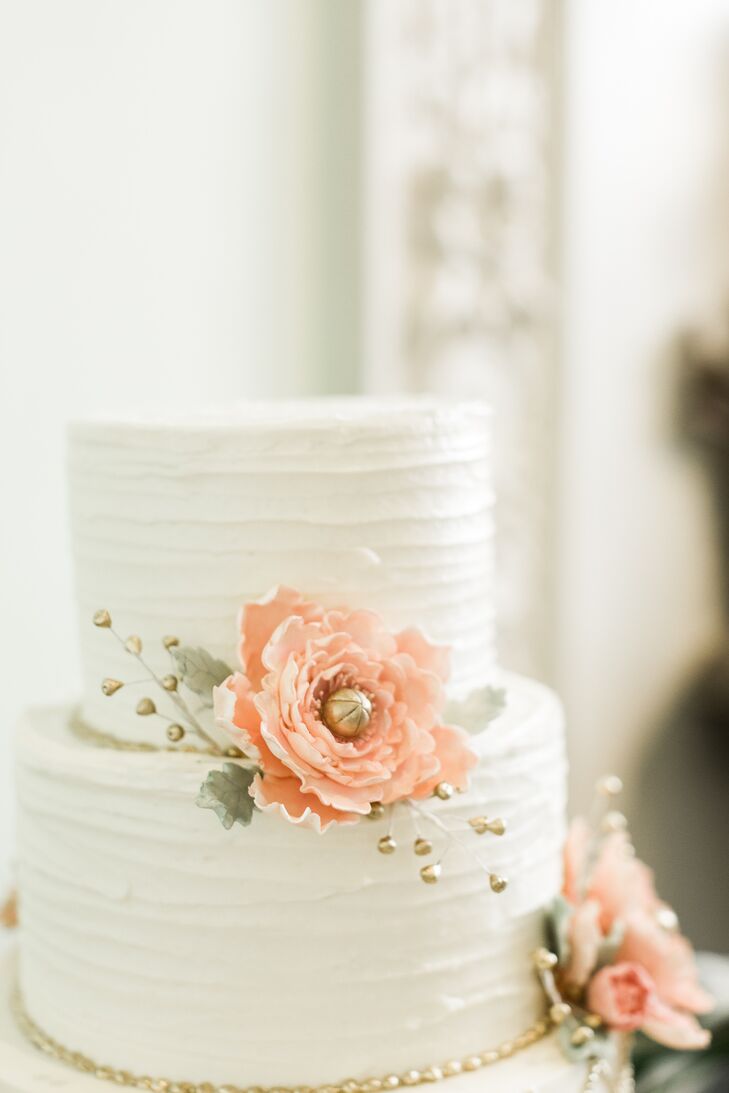 The simple white-tier cake was decorated with fresh peach garden roses. Jason, a hip surgeon, insisted that his groom's cake feature a picture of a pelvis.