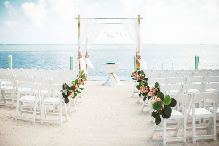 The day kicked off with an intimate ceremony on the beach at the Drop Anchor Resort. Bunches of pink hydrangeas and oversized greenery lined the aisles, adding a fresh punch of color to the sandy white beach. A simple bamboo wedding arch stood at waters edge, draped with airy sheer fabric and a whimsical backdrop of striking white starfish.  rn
