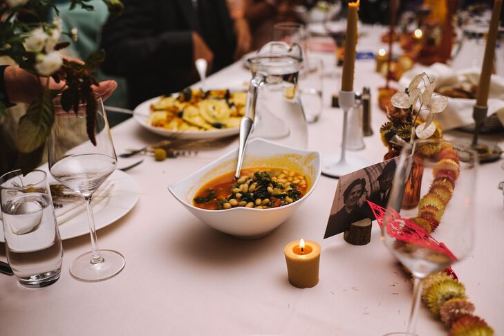 Dining Table With White Linen, Comforting Soup and Other Dinner Foods, Candles