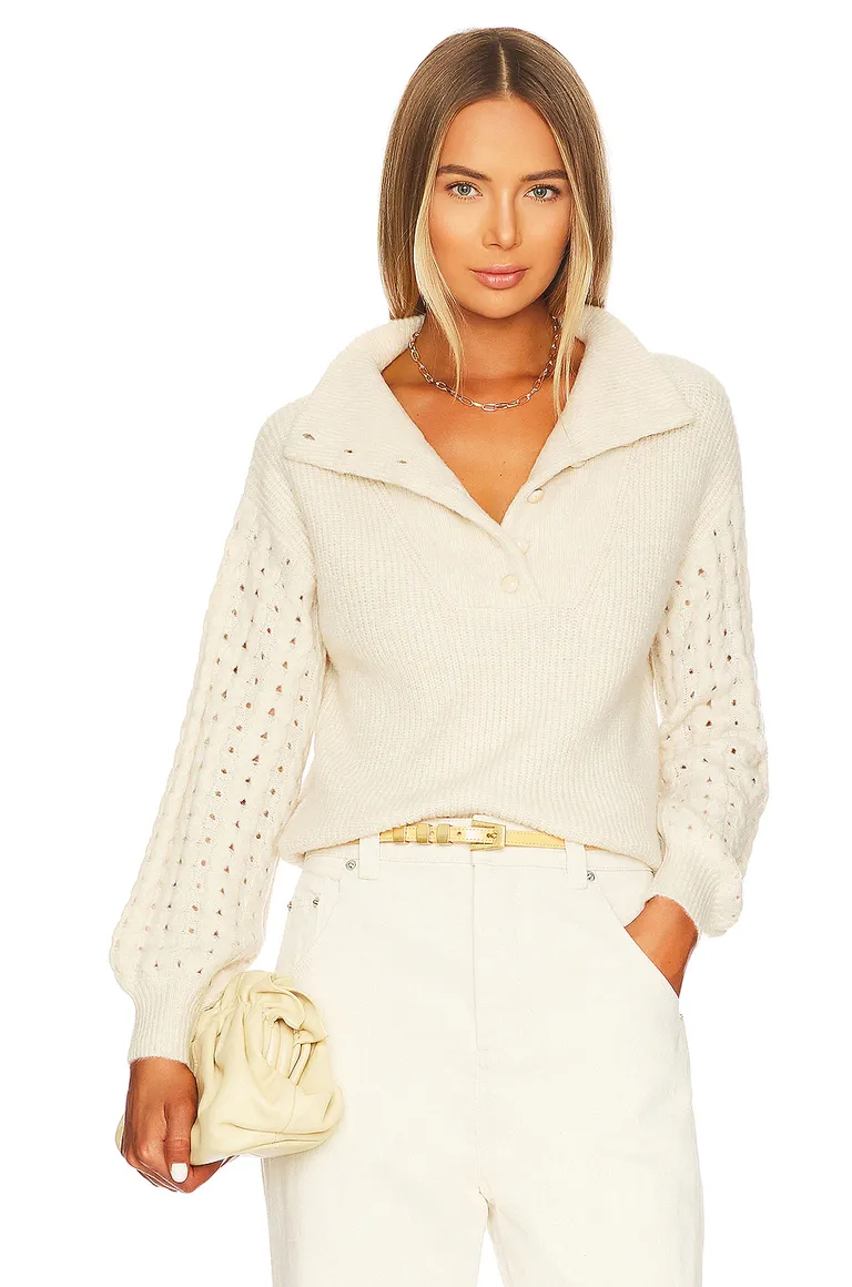 white sweater with collar and holes in sleeves