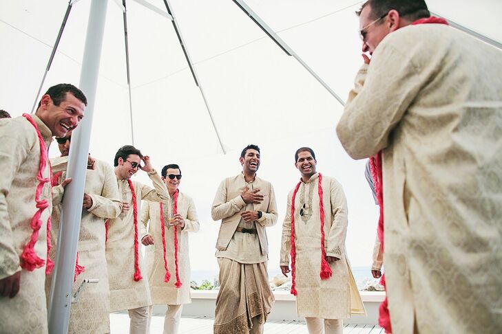 The groom wore a Tarun Tahiliani dhoti and jacket while his groomsmen rocked cream-colored kurtas with bright red scarves.