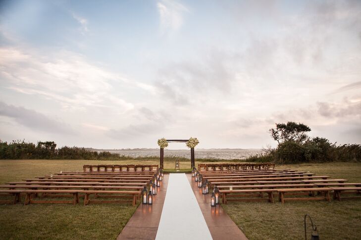 The outdoor ceremony took place on Ludlow Farm in front of Mecox Bay, amongst the sunflowers. Guests sat on wood benches in rows and the women were offered pashminas for the ceremony.
