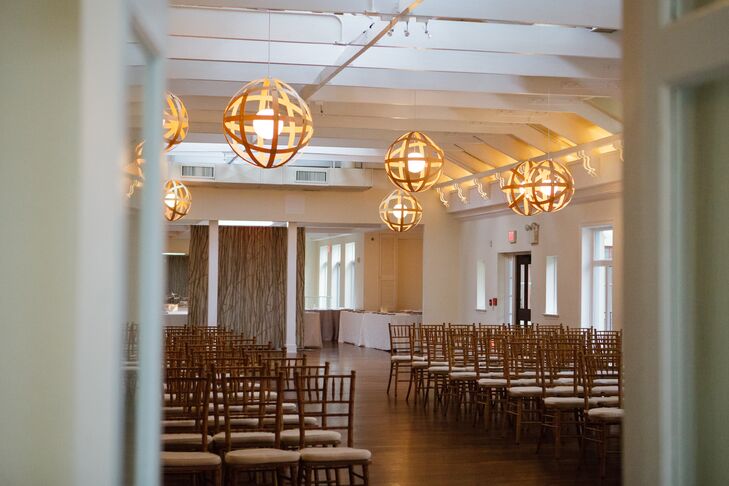 "We fell in love with the beautiful rustic elegance of Pomme," Lily says. "We knew it wouldn't take much to transform it into the romantic candlelit room we imagined." Lily and Aaron chose decor that only enhanced the space. Rows of gold chiavari chairs faced a chic vintage fireplace for the ceremony.