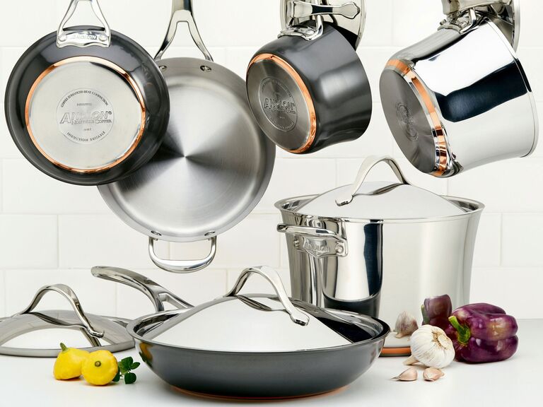 Anolon stainless steel and copper cookware set hanging in kitchen