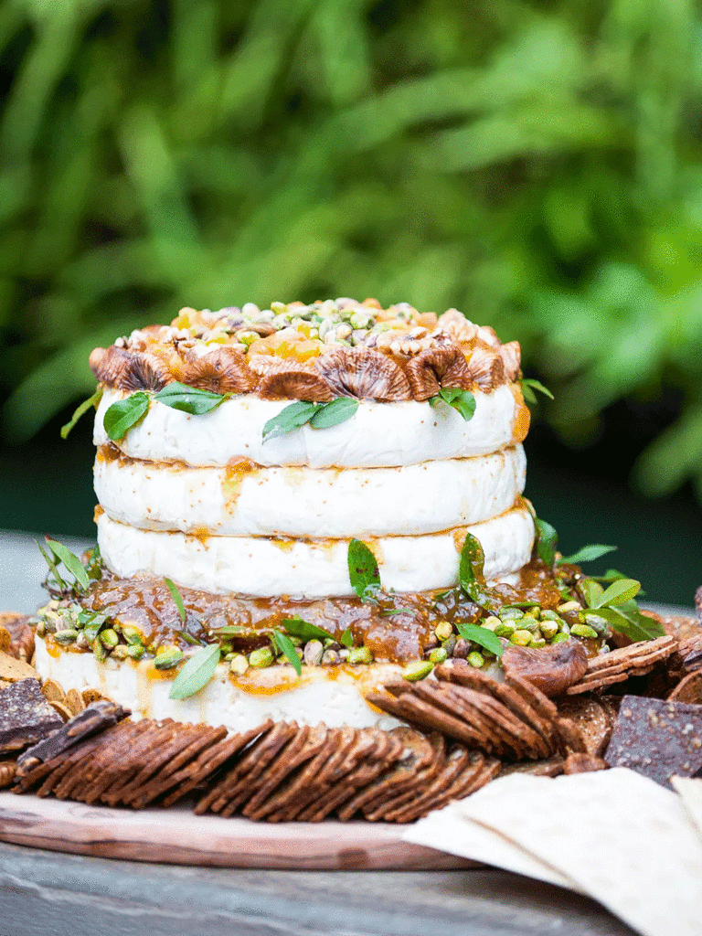 Brie cheese cake wheel served on a couple's winter wedding food menu.