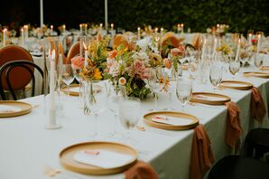 Long Dining Tables With Orange Chargers, Taper Candles, Low Centerpieces With Bright Accents