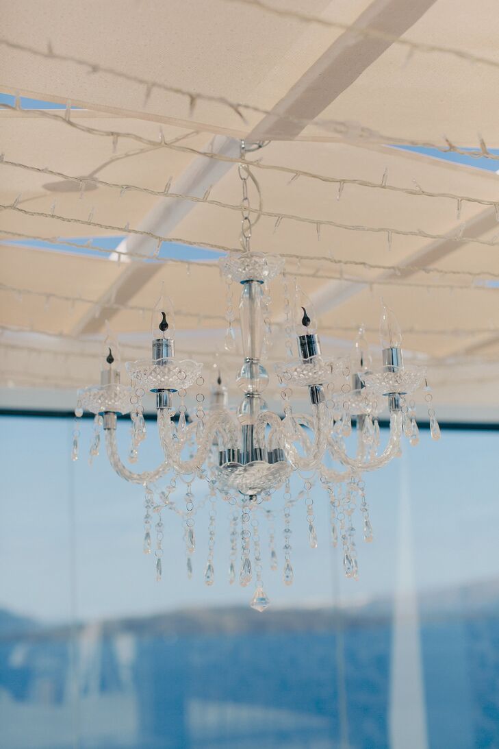 The crystal chandelier hung from the wire gazebo housing the wedding party at their outdoor reception.