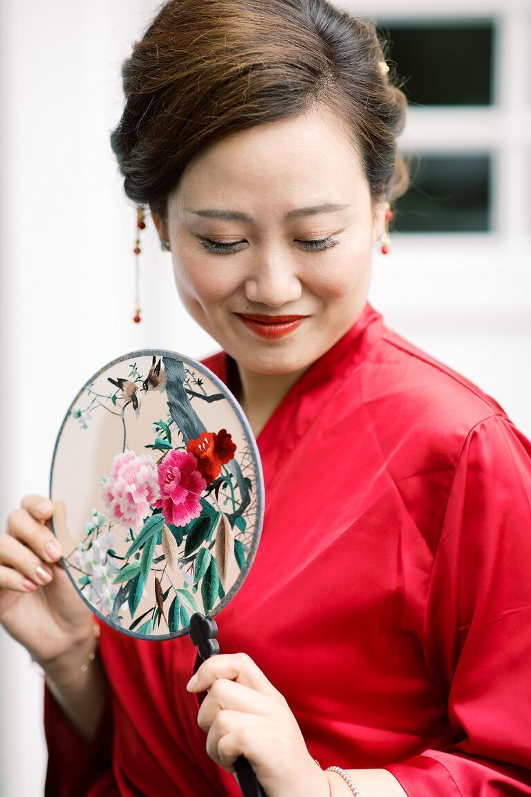 Chinese bride holding ornate fan